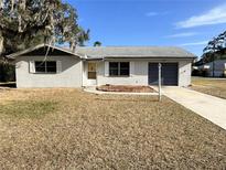 Ranch-style home with attached garage and mature landscaping at 8455 Elgrove St, Spring Hill, FL 34608