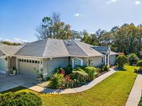 Charming single-story home with landscaped front yard and attached two-car garage at 11654 Holly Ann Dr, New Port Richey, FL 34654