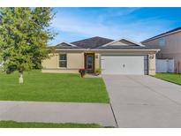 One-story home with attached garage and well-manicured lawn at 4148 Sand Ridge Blvd, Spring Hill, FL 34609