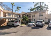 Condo building exterior with parking and landscaping at 7924 Hardwick Dr # 612, New Port Richey, FL 34653