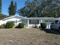 Ranch-style home with carport and mature landscaping at 4392 Craftsbury Dr, New Port Richey, FL 34652