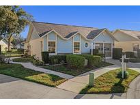 Cute light blue exterior, two-car garage, and well-manicured landscaping at 4808 Vesper Ct, New Port Richey, FL 34655