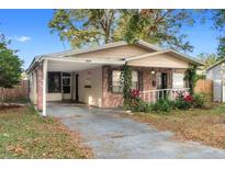 Charming single-story home with a carport, landscaping, and a brick facade at 4939 18Th St, Zephyrhills, FL 33542