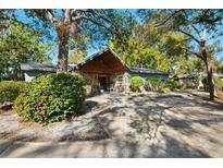 Charming single-story home featuring a stone facade, covered entry, and mature landscaping for enhanced curb appeal at 7600 138Th St, Seminole, FL 33776