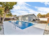 Tranquil backyard retreat with a large inground pool, perfect for relaxation at 15950 Adobe Dr, Hudson, FL 34667