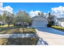 Single-story house with a spacious lawn and attached garage at 4635 Bellemede Blvd, New Port Richey, FL 34655