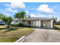 Ranch-style home with a spacious yard and driveway at 106 Aurora E St, Venice, FL 34285