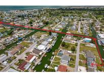 Aerial view of waterfront community with canal access to bay in a residential neighborhood at 13802 Judy Ave, Hudson, FL 34667