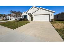 Charming one-story home featuring a well-manicured lawn and a two-car garage at 3337 Autumn Amber Dr, Spring Hill, FL 34609