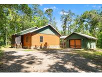 Charming log cabin home with lush surroundings and separate garage at 6051 Valley Spring Dr, Brooksville, FL 34601