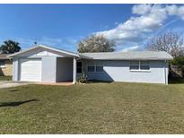 Charming single-story home with a well-manicured lawn and attached garage at 3421 Allandale Dr, Holiday, FL 34691