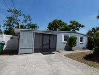 Cozy single story home featuring a screened in porch and tidy landscaping at 4011 W Mango Ave, Tampa, FL 33616