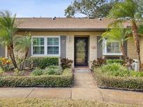Charming home featuring well-maintained landscaping, stone accents, and a welcoming front entrance at 3259 Hilary Cir # 1C, Palm Harbor, FL 34684