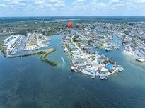 Expansive aerial view showcases the waterfront property with its scenic canals and boat docks at 14124 Kulig Ct, Hudson, FL 34667