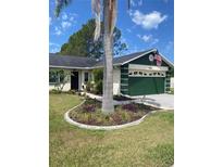 Charming single-story home featuring a landscaped front yard and an attached two-car garage at 4649 Westerly Dr, New Port Richey, FL 34653