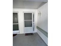 Inviting front door with screen and lock, with a decorative lamp at 4218 San Rafael Ave, New Port Richey, FL 34655