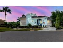 Charming home with blue exterior, a welcoming porch and well-maintained landscaping enhancing its curb appeal at 5771 Catskill Rd, Holiday, FL 34690