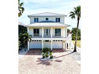 Stunning two-story home with a brick driveway, multiple car garage, and a charming balcony at 1421 Apollo Beach Blvd, Apollo Beach, FL 33572