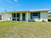 Charming single-story home featuring a quaint front porch and well-manicured lawn at 3523 Cambridge St, New Port Richey, FL 34652