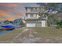 Stunning waterfront home with balconies, boat lift, and convenient garage access at 6801 Nowiki Ave, Hudson, FL 34667
