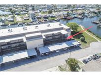 Beautiful waterfront condo featuring an elegant exterior and convenient covered parking at 4452 Garnet Dr # 101, New Port Richey, FL 34652