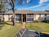 Two-story condo building featuring screened balconies, covered entry and convenient accessible parking spaces at 13103 Cypress Hill Dr # B2, Hudson, FL 34669