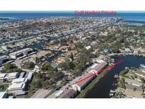 This aerial showcases the waterfront property with private canal access and stunning Gulf Harbor views at 4533 Marine Pkwy # 206, New Port Richey, FL 34652