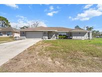 Charming single-story home with a well-maintained lawn and attached two-car garage, perfect for suburban living at 13419 Banner Rd, Spring Hill, FL 34609