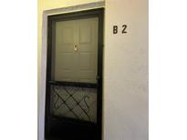 Condo front door with security screen and the unit number clearly displayed at 2642 Pine Ridge S Way # B2, Palm Harbor, FL 34684