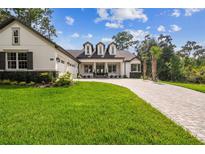Charming two-story home with landscaped yard and brick driveway, a suburban oasis at 6452 Summit View Dr, Brooksville, FL 34601