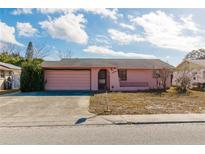 Charming single-story home featuring an attached garage and low maintenance landscaping at 8846 Tropical Palm Way, Port Richey, FL 34668