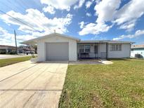 Charming single-story home with a well-maintained front yard and attached one car garage at 9005 Prosperity Ln, Port Richey, FL 34668