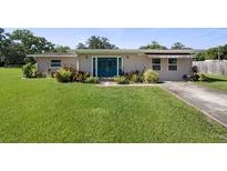 Charming single-story home with a well-manicured front lawn and inviting double door entry at 12757 Circle Lake Dr, Hudson, FL 34669