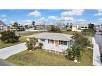 Charming one-story home featuring a well-maintained front yard and a spacious concrete driveway at 3449 Companero Entra, Hernando Beach, FL 34607