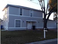 Two-story home featuring a gray exterior, white trim, front yard, and a mailbox at 3801 Kimball Ave, Tampa, FL 33614
