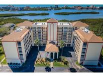Waterfront condo complex boasts lush landscaping, covered parking, and beautiful water views at 9000 Commodore Dr # 302, Seminole, FL 33776
