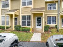 Charming townhouse exterior featuring well-maintained landscaping, covered entryway, and natural light from large windows at 2843 Thaxton Dr # 34, Palm Harbor, FL 34684