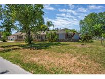 Charming single-story home featuring mature trees and a well-manicured lawn in a quiet neighborhood at 5345 Carlton Rd, New Port Richey, FL 34652