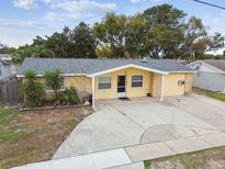 Charming single-story home with a well-maintained lawn and a spacious driveway at 7427 Congress St, New Port Richey, FL 34653