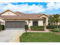 Charming single Gathering home with a well manicured lawn and an attached two car garage at 9405 Palm Haven Ct, New Port Richey, FL 34655