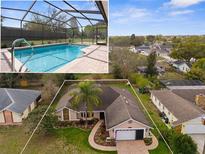 Inviting single-story home showcasing a screened pool and well-maintained lawn with mature landscaping and a brick driveway at 1382 Aladdin Rd, Spring Hill, FL 34609