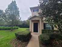 Charming townhouse with manicured front lawn and walkway leading to the front door at 15772 Stable Run Dr, Spring Hill, FL 34610
