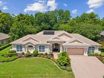 Stunning single-story home featuring a tile roof, manicured landscaping, and an attached two-car garage at 5383 Firethorn Pt, Spring Hill, FL 34609