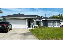 Charming single-story home with a manicured lawn and two-car garage, perfect for comfortable suburban living at 5801 65Th N Ter, Pinellas Park, FL 33781