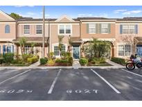Charming townhouse with colorful facade, manicured landscaping, and dedicated parking spot at 6027 Bayside Key Dr, Tampa, FL 33615