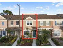 Townhome featuring a well-maintained facade and landscaped front yard at 6027 Bayside Key Dr, Tampa, FL 33615