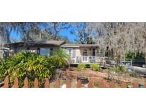 Charming single-story home featuring a well-maintained front yard with lush landscaping and a welcoming entrance at 6825 Main St, New Port Richey, FL 34653