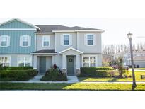 Charming townhome with a well-manicured lawn and beautiful landscaping at 15384 Caravan Ave, Odessa, FL 33556