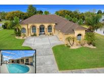 Stunning home with a large driveway, arched entryway, tropical landscaping, and a refreshing screened-in pool at 3542 Conifer Loop, Spring Hill, FL 34609