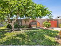 Charming single-story home with a gated entrance and lush green lawn at 3730 Sail Dr, New Port Richey, FL 34652